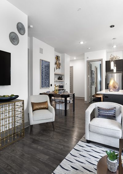 Modern living space with sleek furniture, dark wood flooring, and neutral-toned decor accents.
