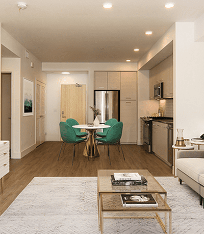 Modern open-concept living space with a kitchen, dining area, and stylish furnishings.