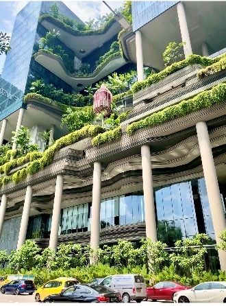 A modern building with lush greenery integrated into its architectural design.