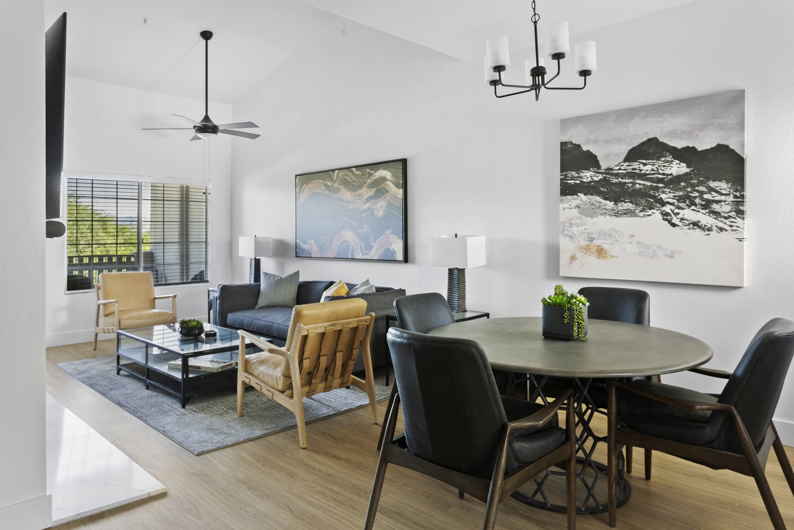 Modern living and dining area with neutral tones, sleek furniture, and contemporary decor.