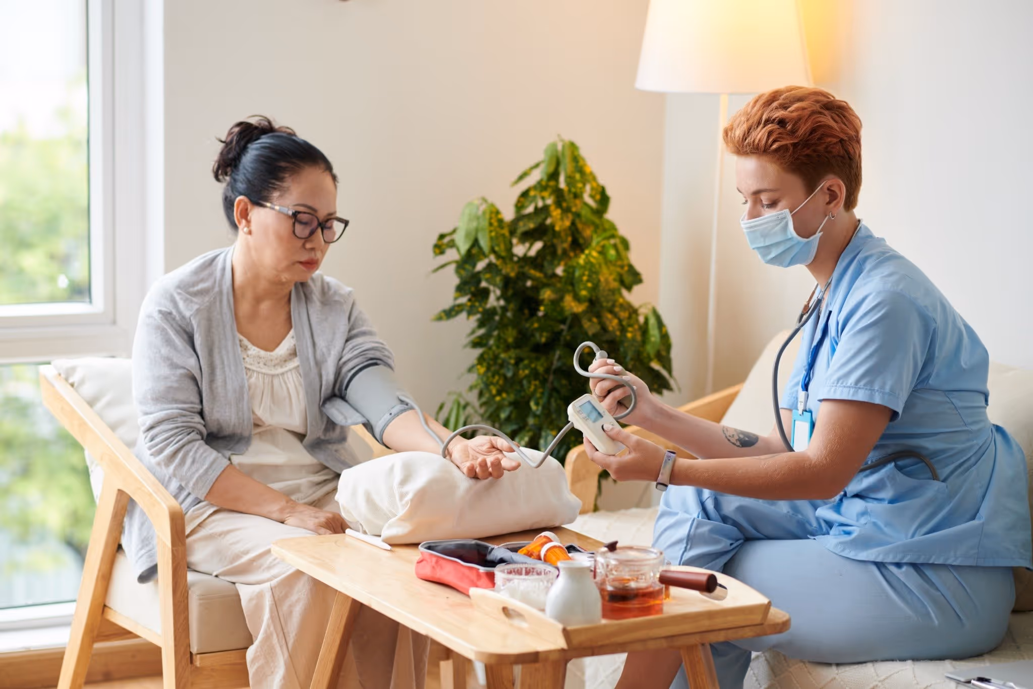A nurse checking a woman blood pressure 