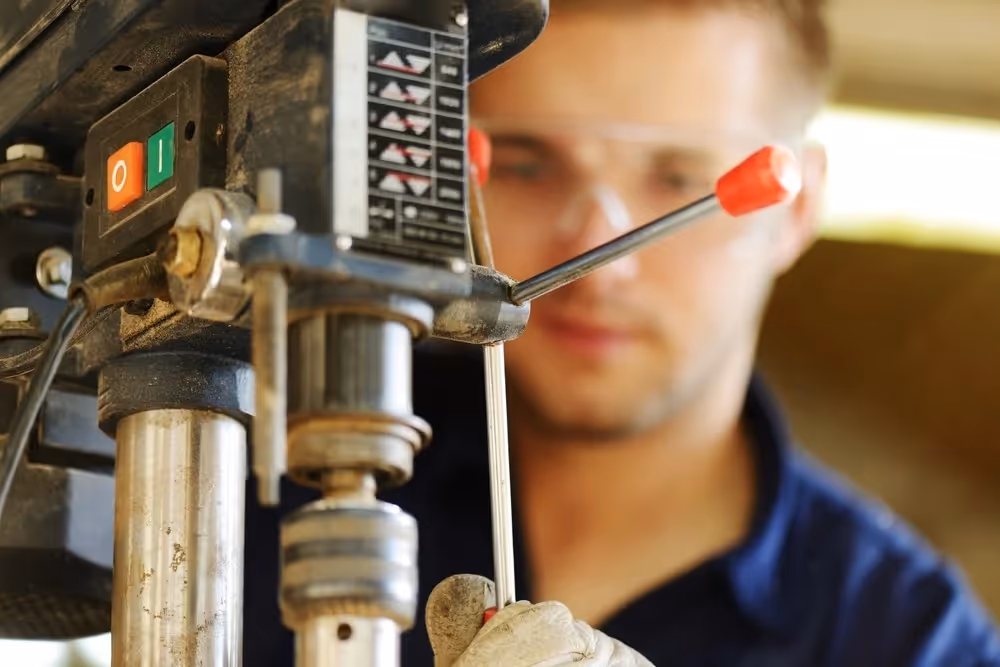 Young worker focused on a task while working in an industrial workshop