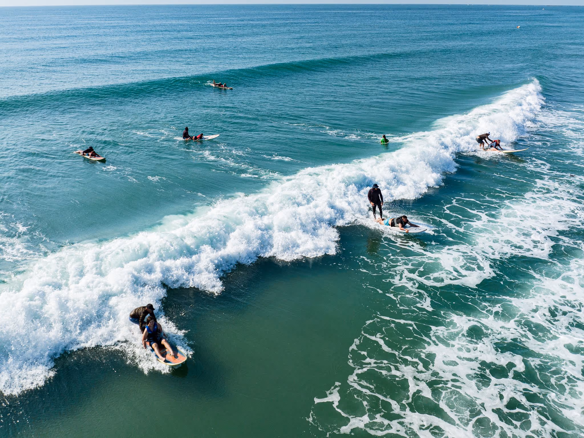 Surfers volunteer with autistic children