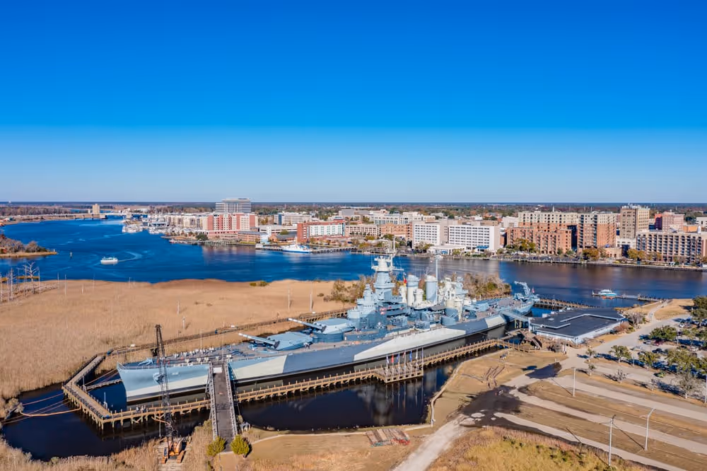 A large battleship docked at a harbor