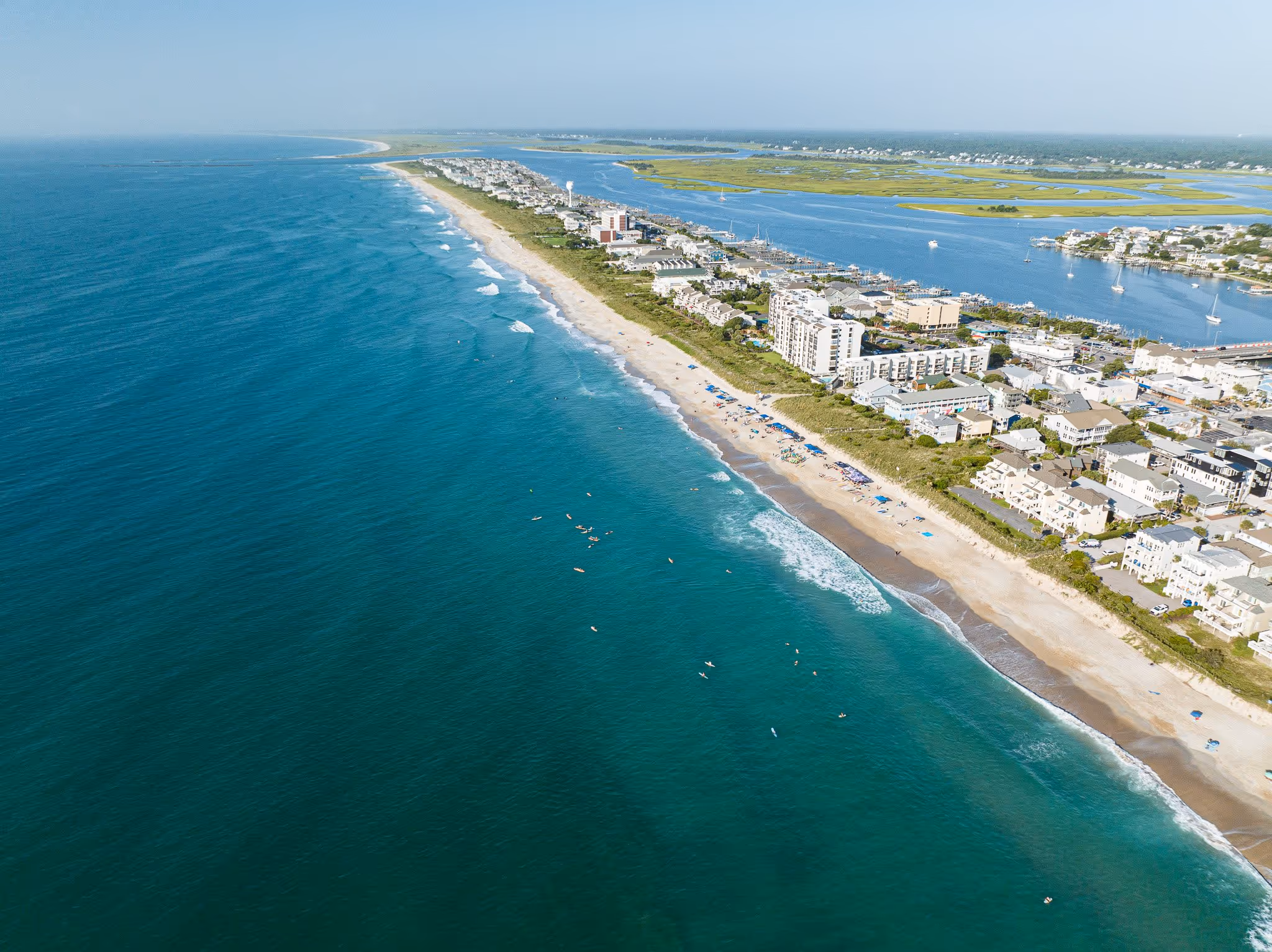 Aerial view of beachfront town along coast.