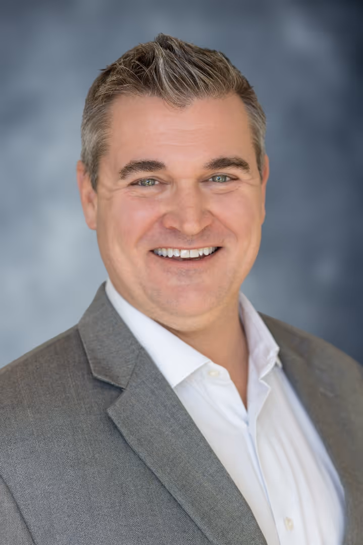 A portrait photograph of Chris Burkauskas