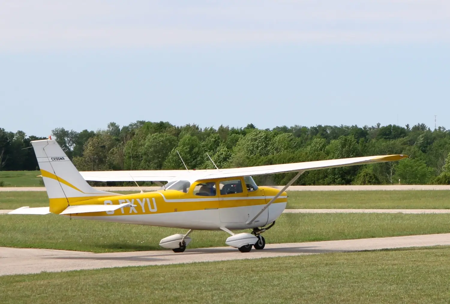 A small prop plane on an open runway