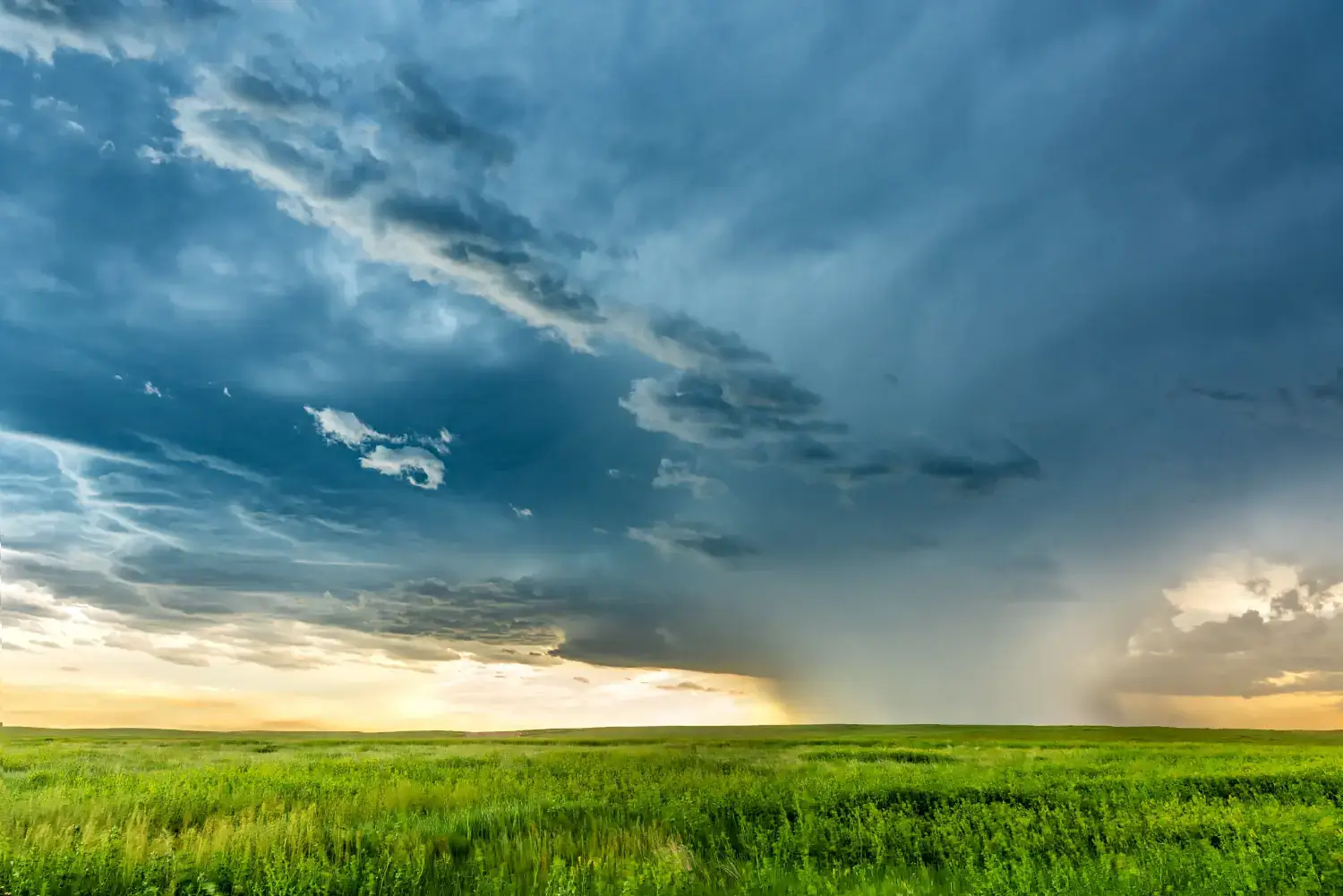 A tornado forming over a valley as he sun sets