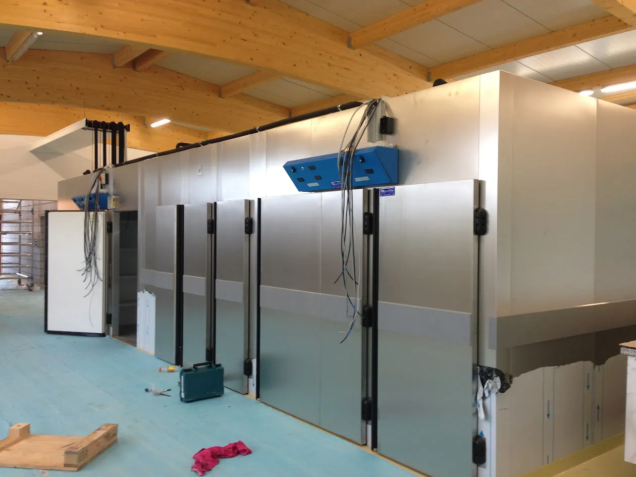 Vous voyez ici l'installation d'un réfrigérateur dans une salle de sport pour l'entreprise J. Le réfrigérateur propose des collations et des boissons saines aux membres.