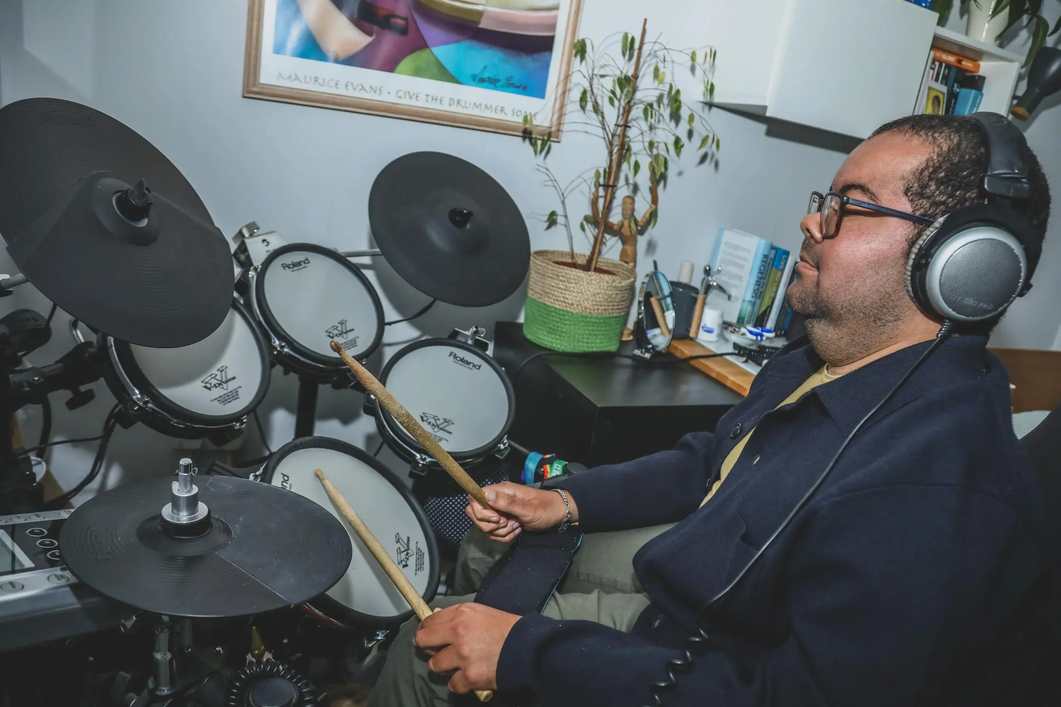 Drummer playing on a Roland electronic drum kit