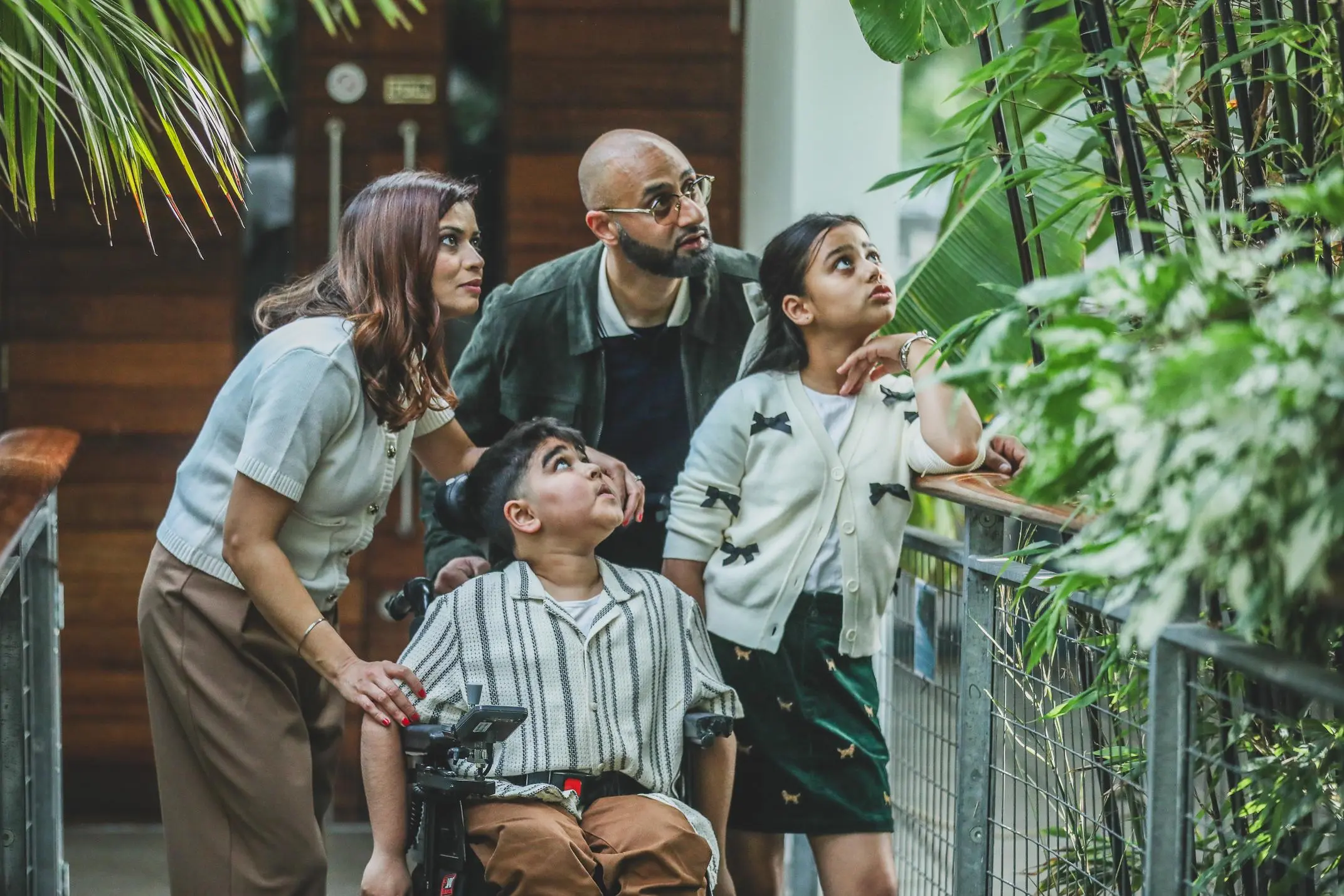 Family with a boy in a wheelchair enjoying time in nature