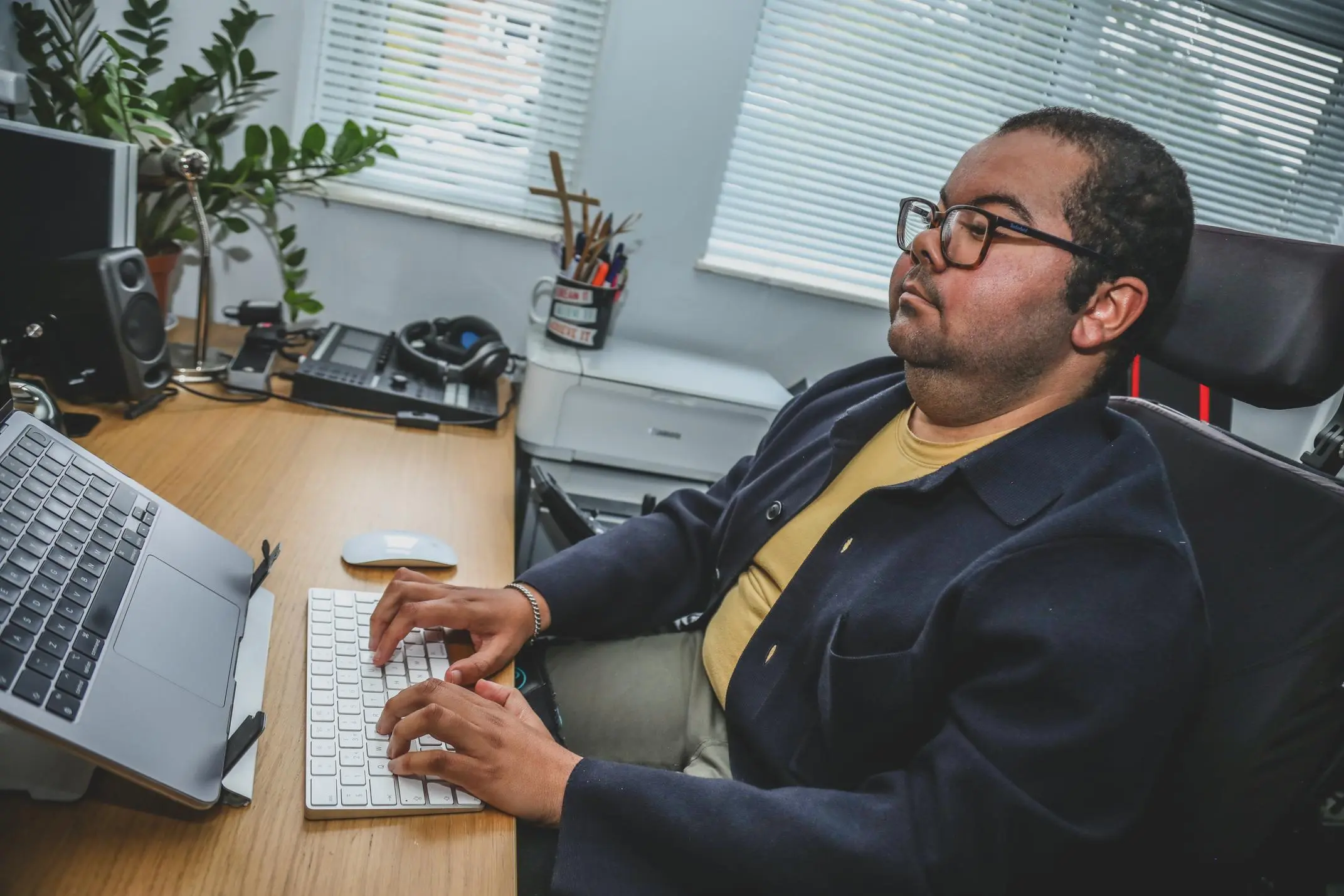 Man working from home at a desk with a computer