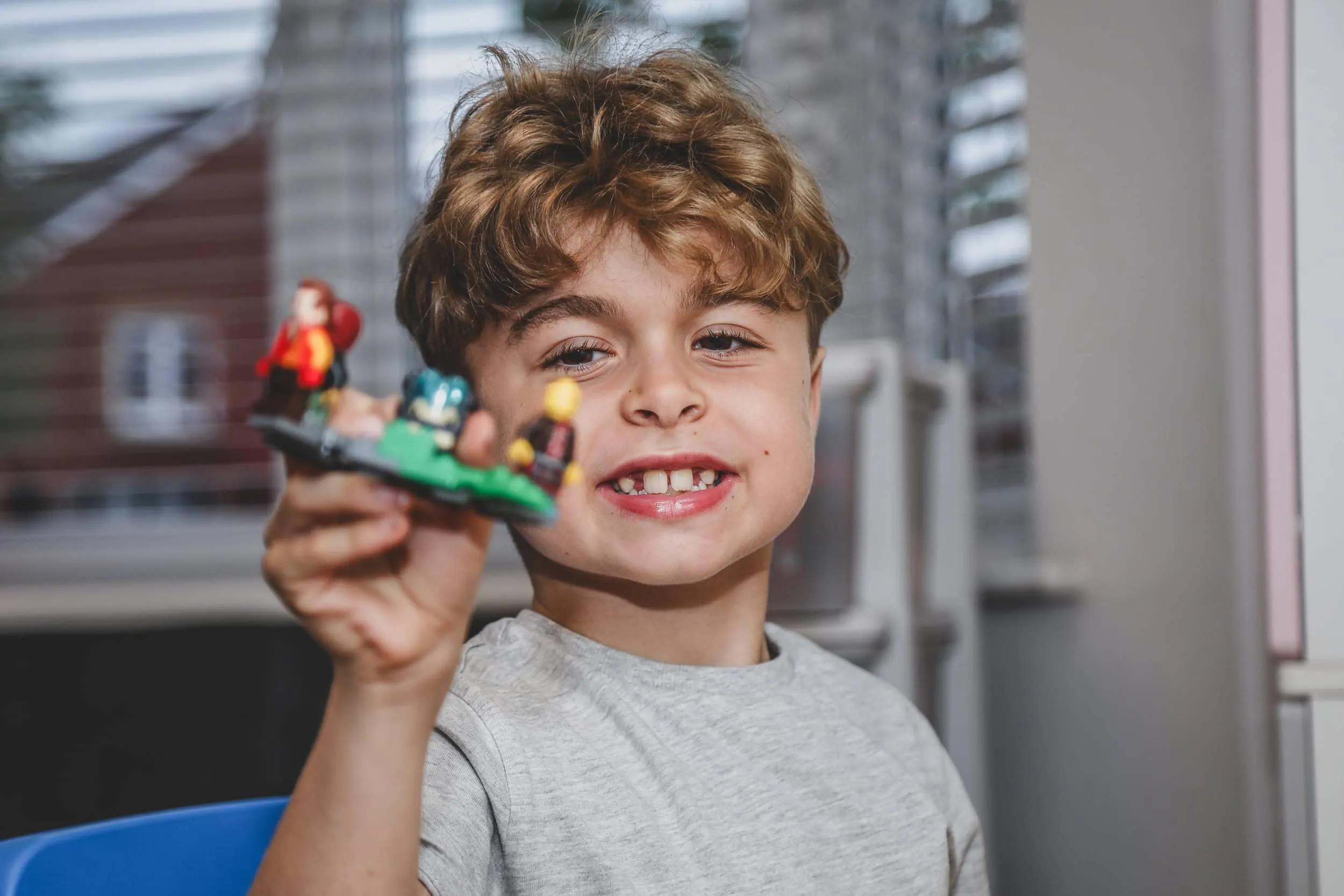 Boy playing with colorful Lego building blocks