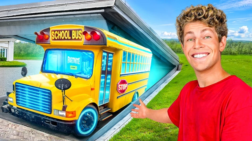 A smiling man with curly hair and a red shirt gestures toward a bright yellow school bus emerging from a tunnel-like structure, with a green grass field and blue sky background.