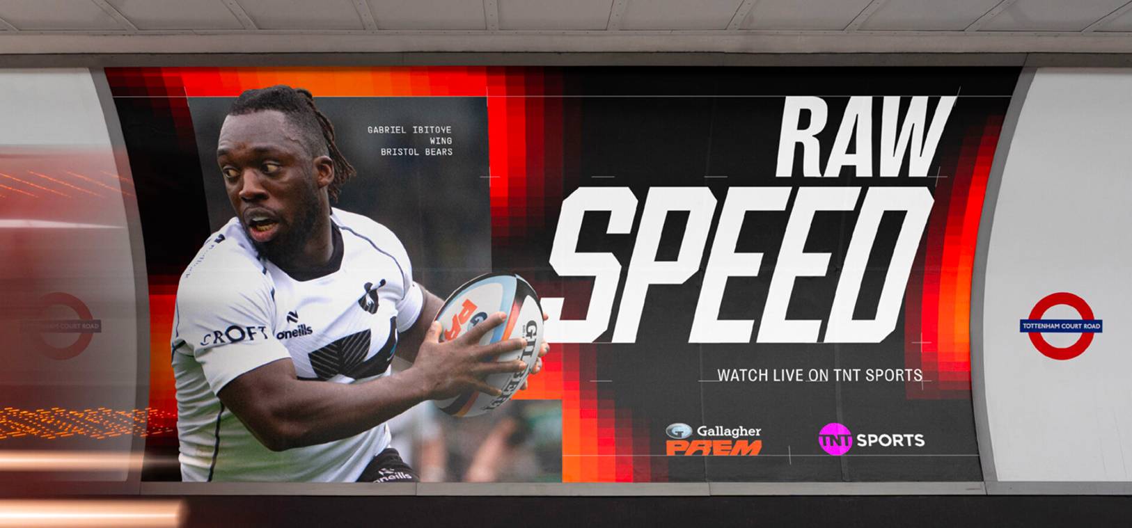 A subway billboard promoting raw speed, featuring bold graphics and vibrant colours, captures commuters' attention.