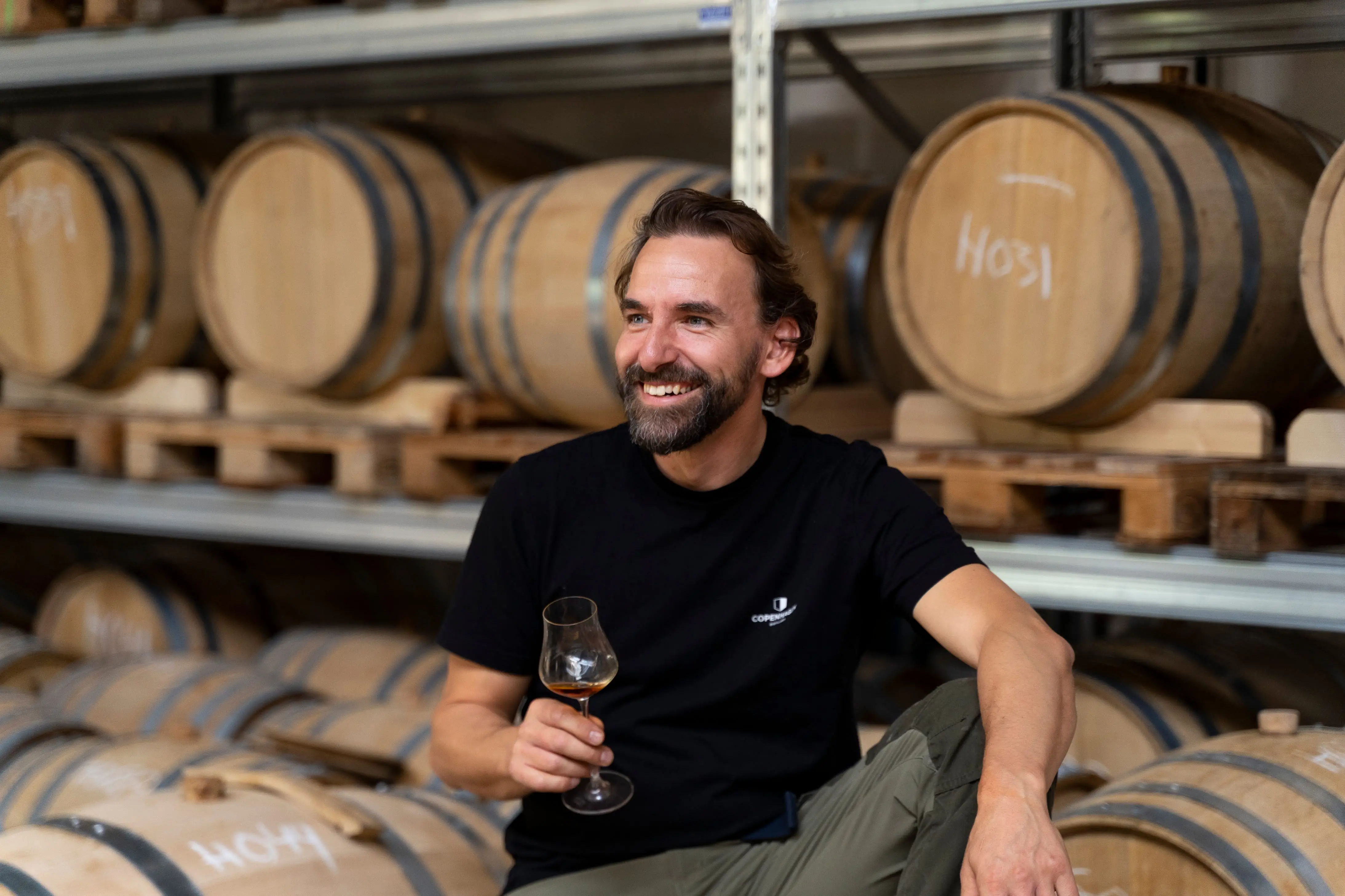 Man drinking whiskey in the distiller