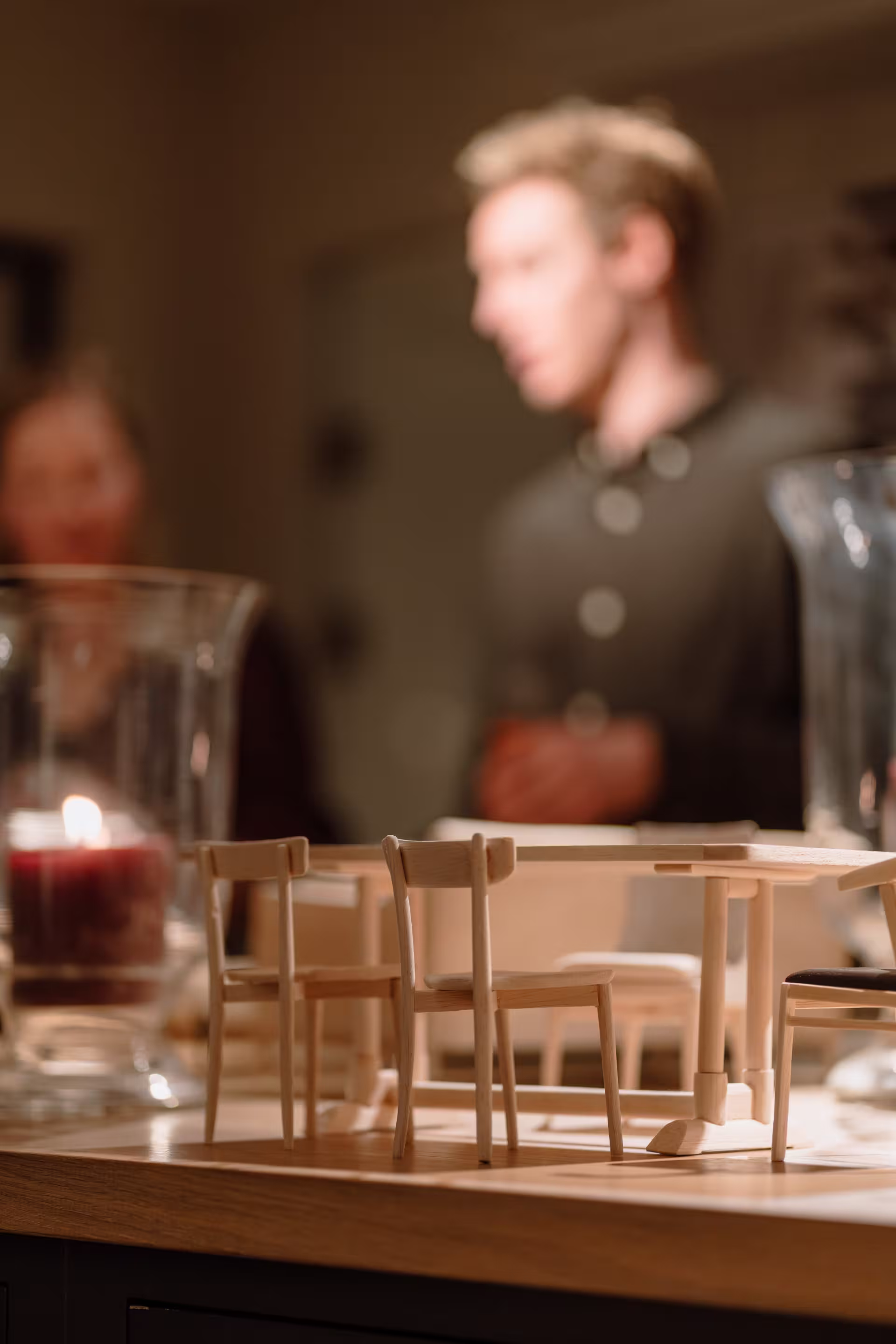 A man and a woman are positioned in the background of the image, engaged in conversation.