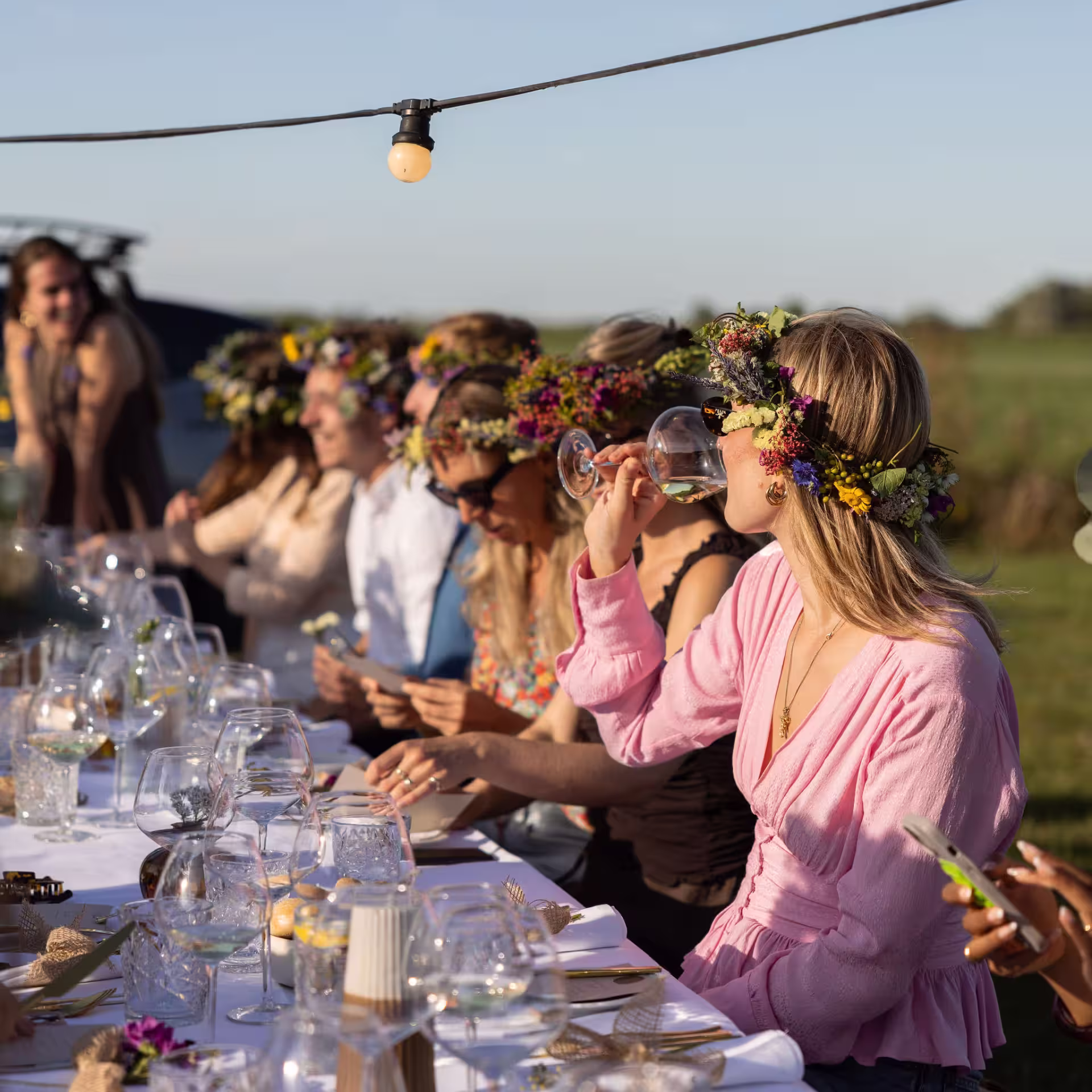 a group of friends at a volvo event enjoying lunch around a table