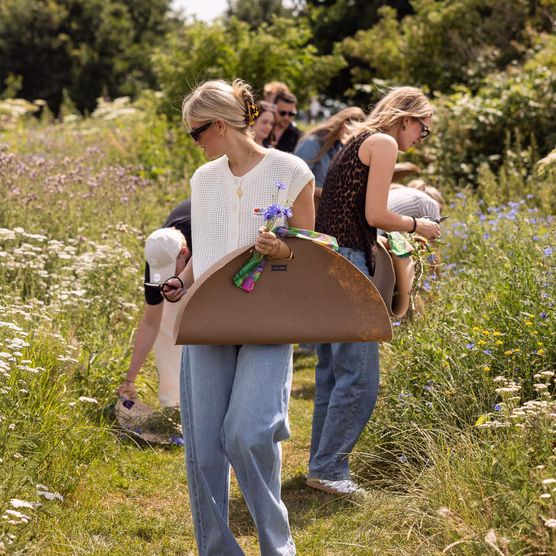 a young woman walking a field of wild flowers