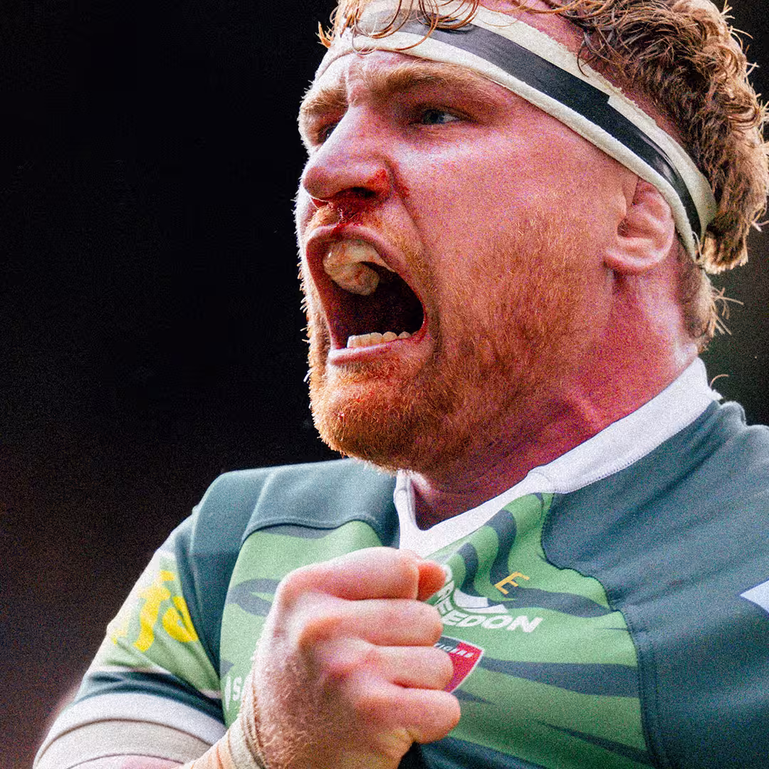 Rugby player screaming proudly grabbing his club shirt