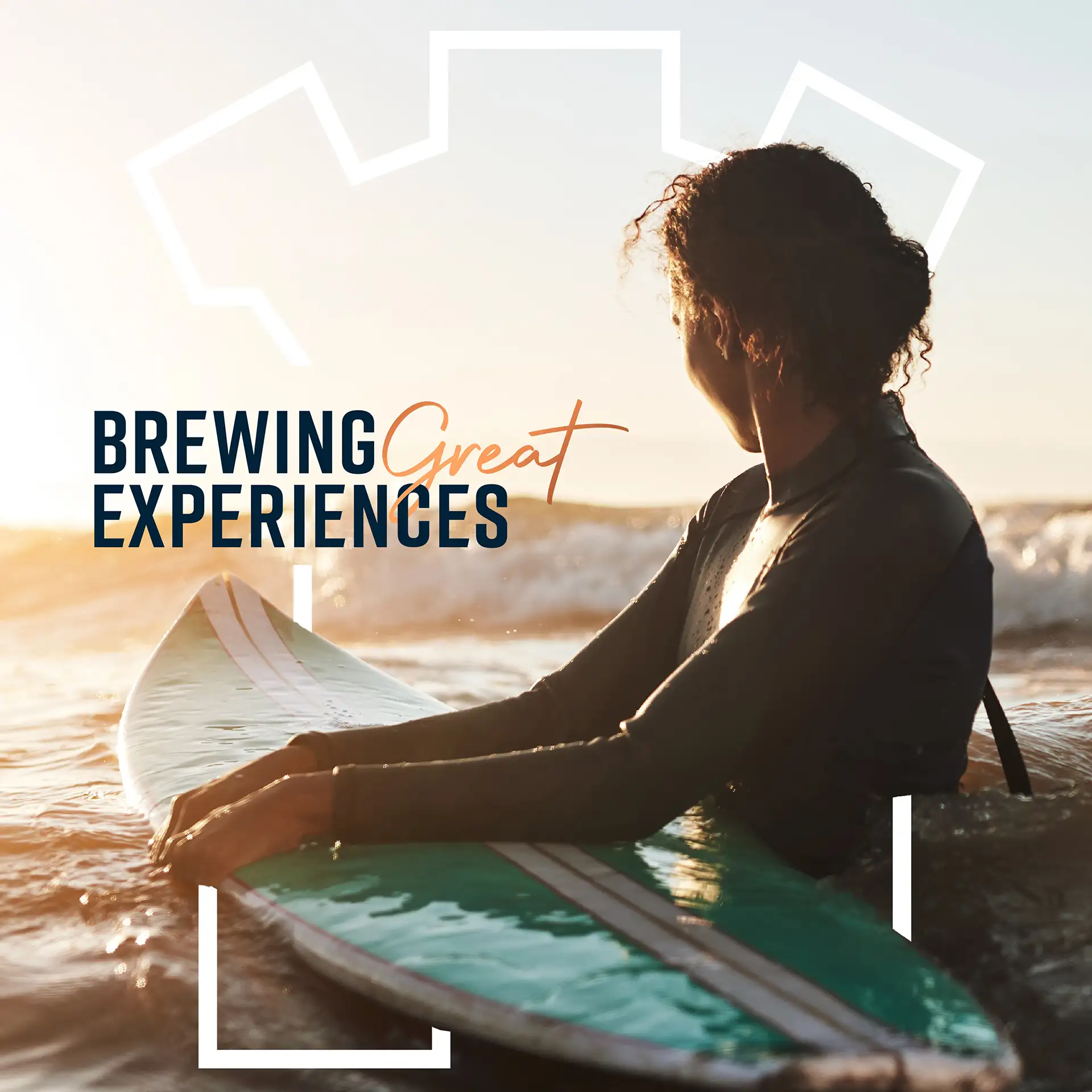 a young lady in the surf waiting for the next wave with the text 'brewing great experiences' written on top of the image