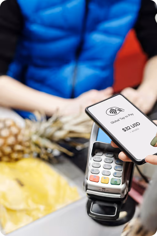 Customer using a smartphone to make a $32 contactless payment at a card reader.