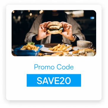 Person holding a burger with plates of fries and other food on the table, with text 'Promo Code SAVE20'.