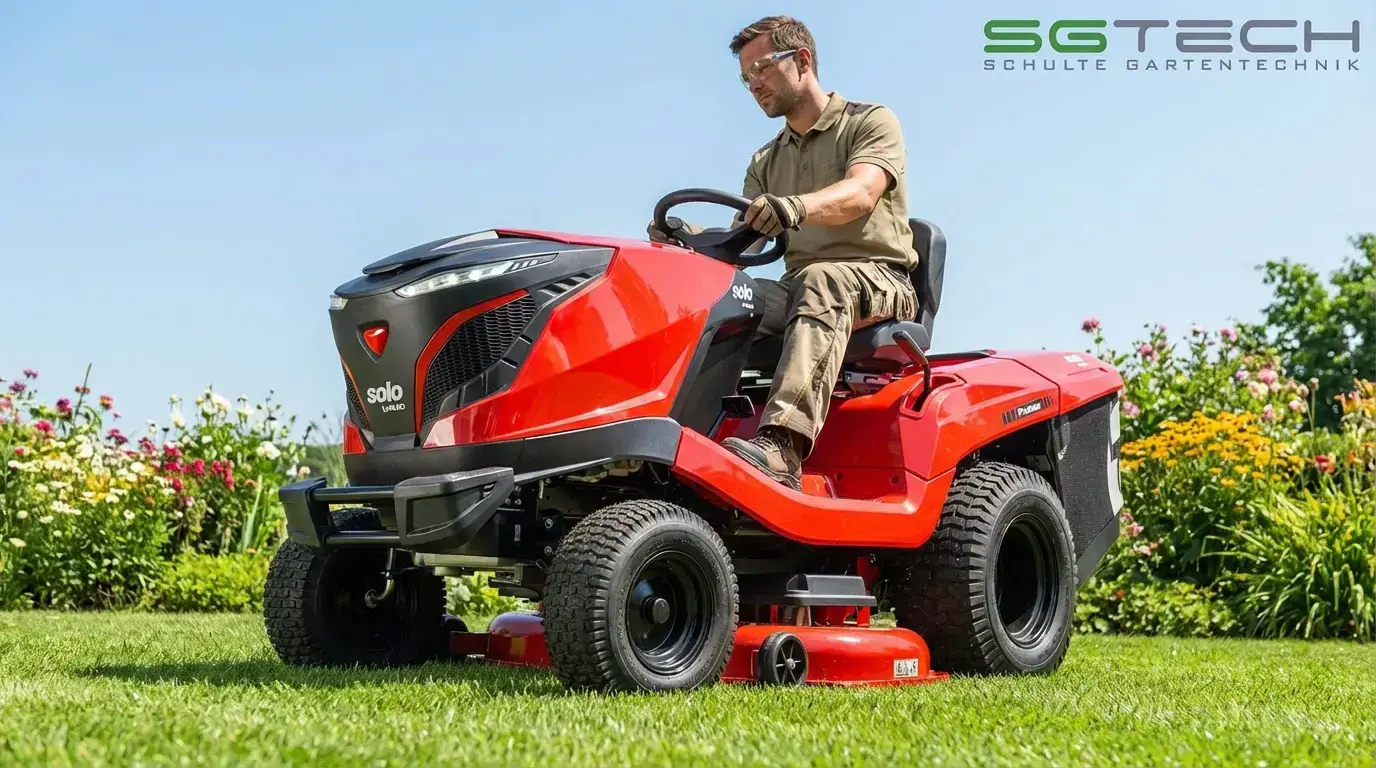Mann fährt einen roten Solo by ALKO T22-105.4HD V2 SD Rasentraktor auf grünem Rasen bei sonnigem Wetter. Rasenpflege im Sommer.