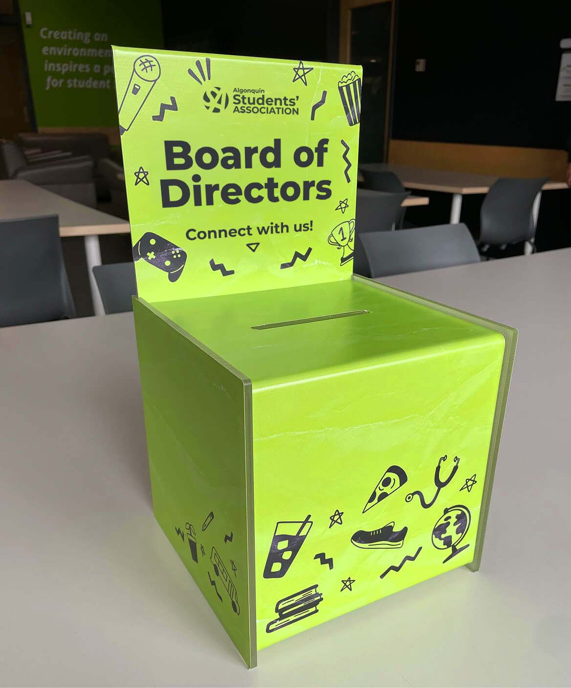 Ballot box wrapped with Algonquin Students' Association branded doodles and Board of Directors title