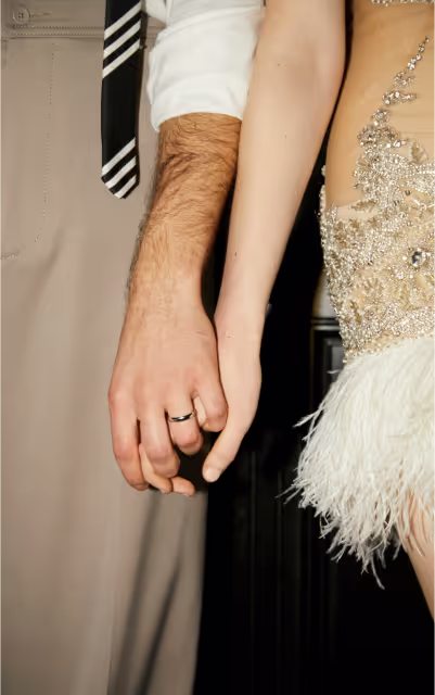 A couple holding hands at a wedding