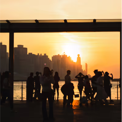 A group of people in front of a city