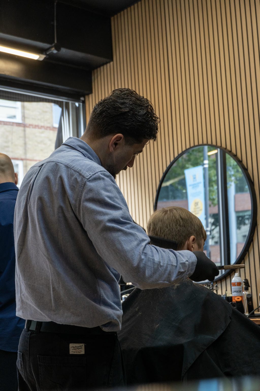 Man providing haircut at AB Barbers