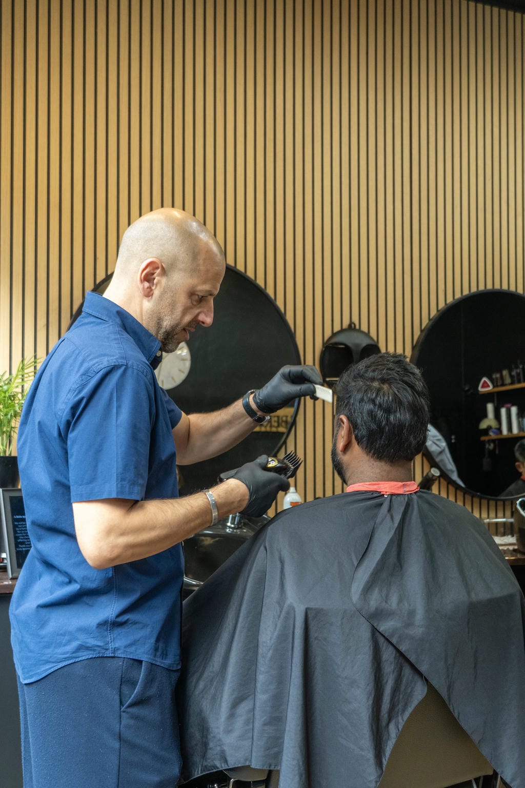 AB Barbers Barbershop Owner serving customer