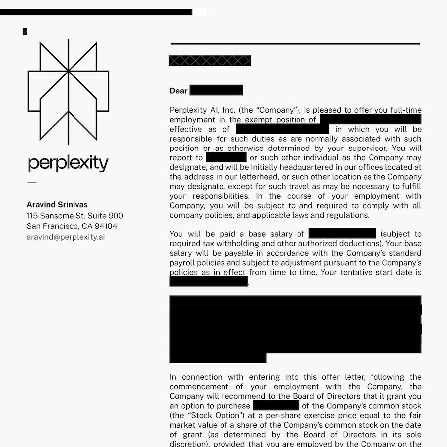 Young man with glasses and dark hair wearing a light pink shirt sitting indoors with abstract wall art in the background.