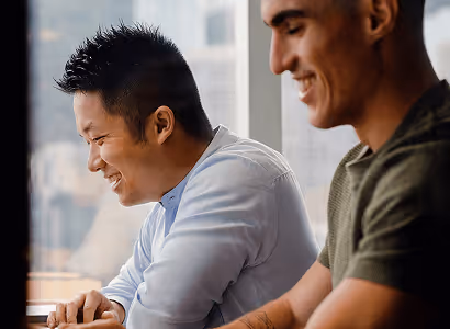 Two men smiling