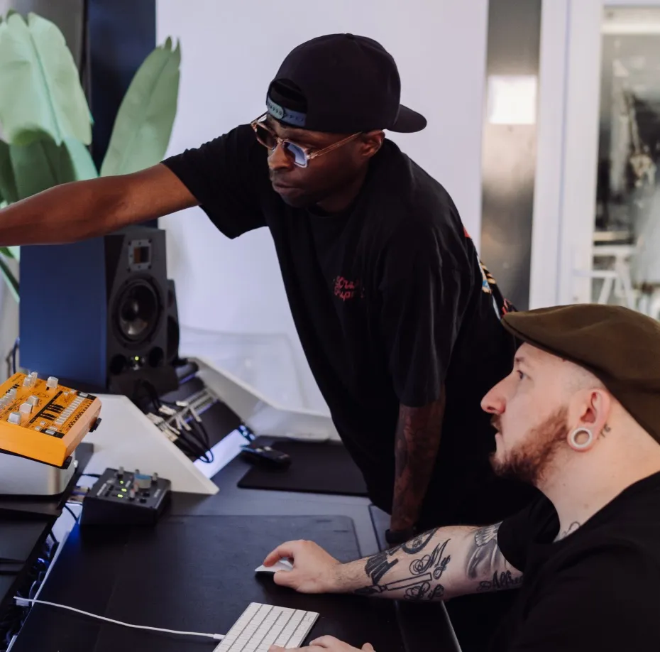 DJs working together to plan the perfect DJ mix during a team-building exercise