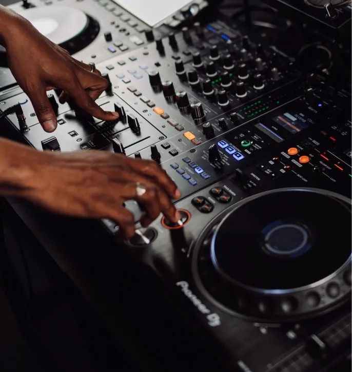 Close up of a man DJing with industry-standard Pioneer DJ equipment