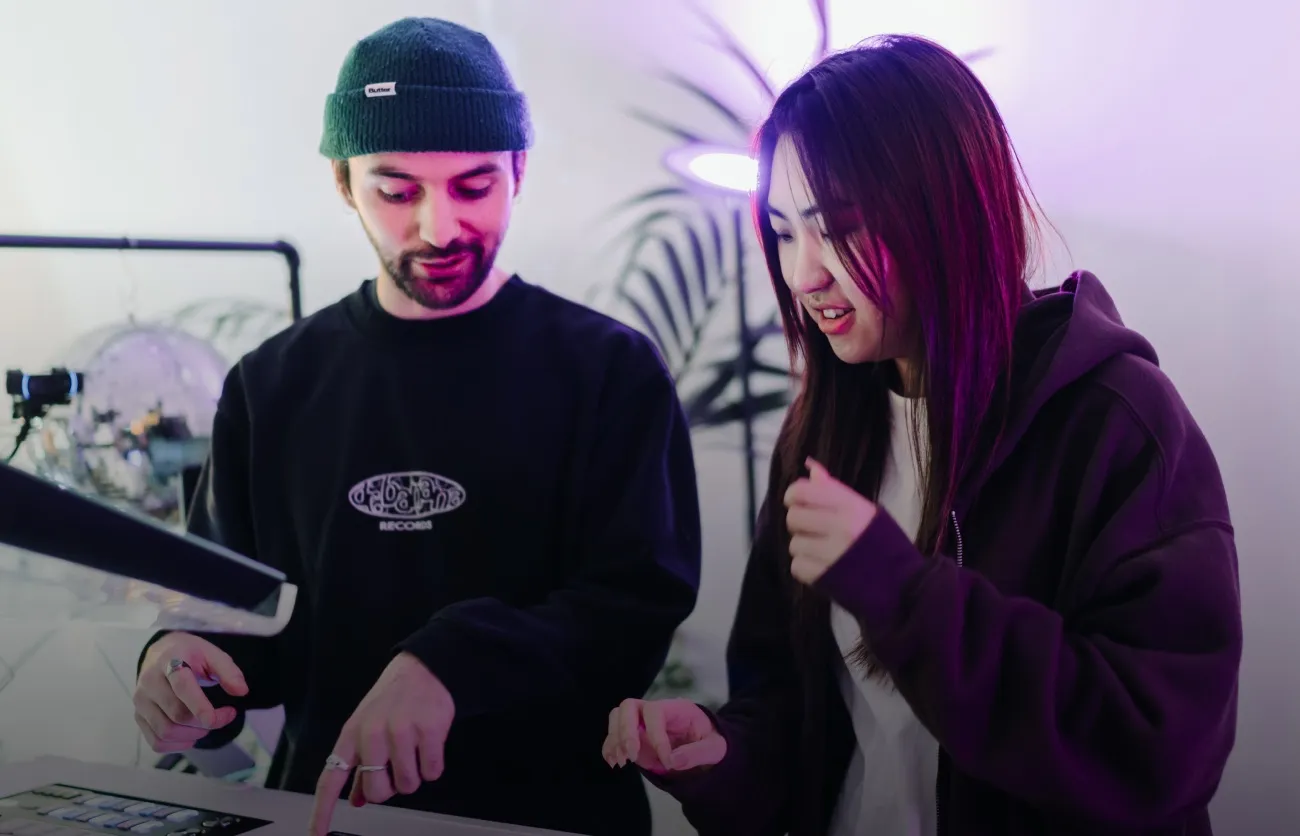 A beginner DJ course student learns the ropes using CDJs and a mixer