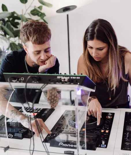An intermediate DJ course student learns the complex settings of the industry-standard DJ setup.