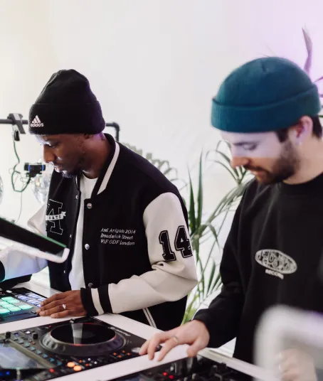 Two DJs practice their intermediate DJ course homework.