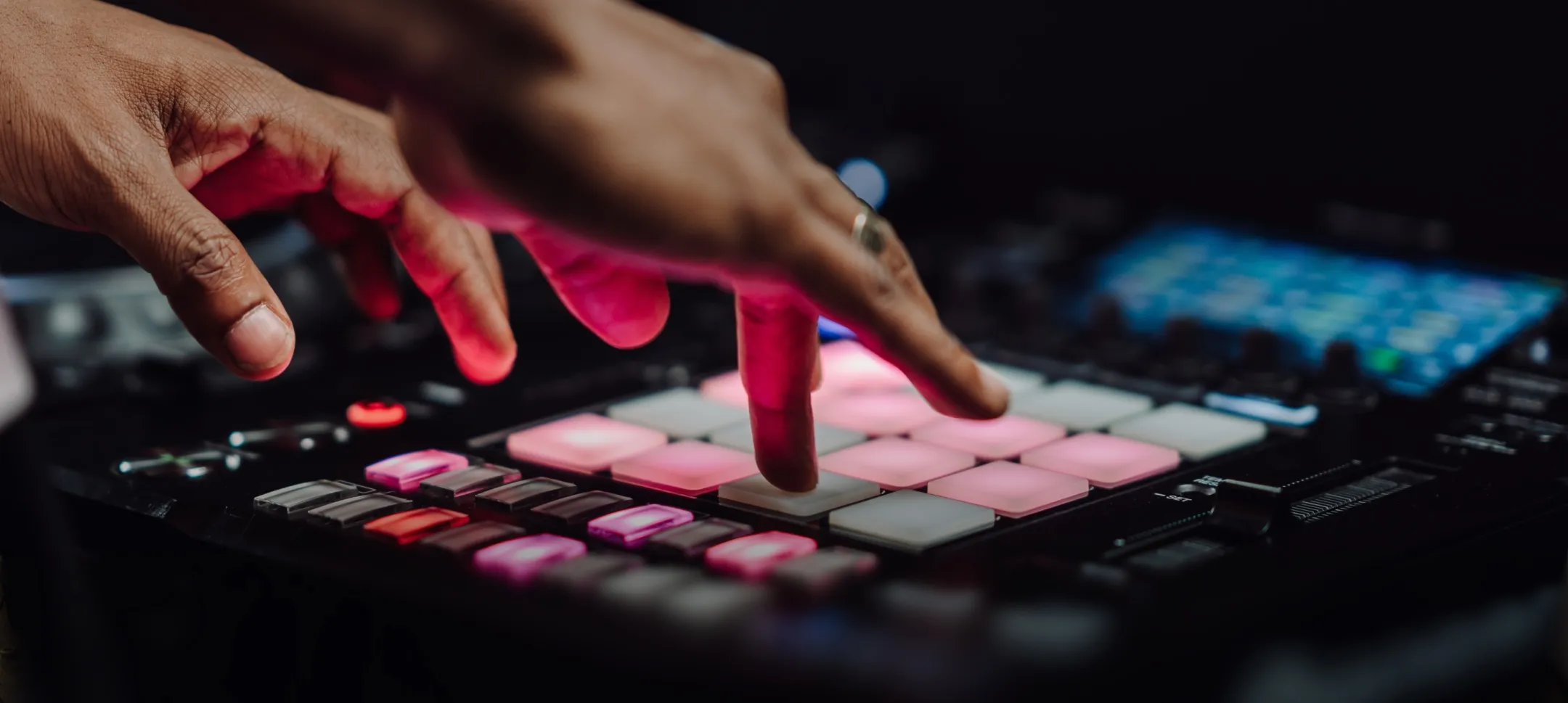 An elite DJ course student drums their fingers on the DJS1000 sampler. 