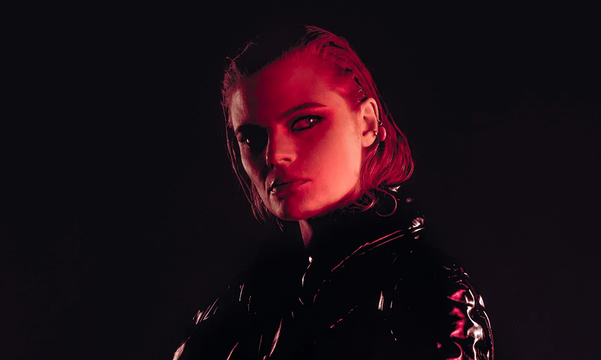 A dark red portrait of a DJ