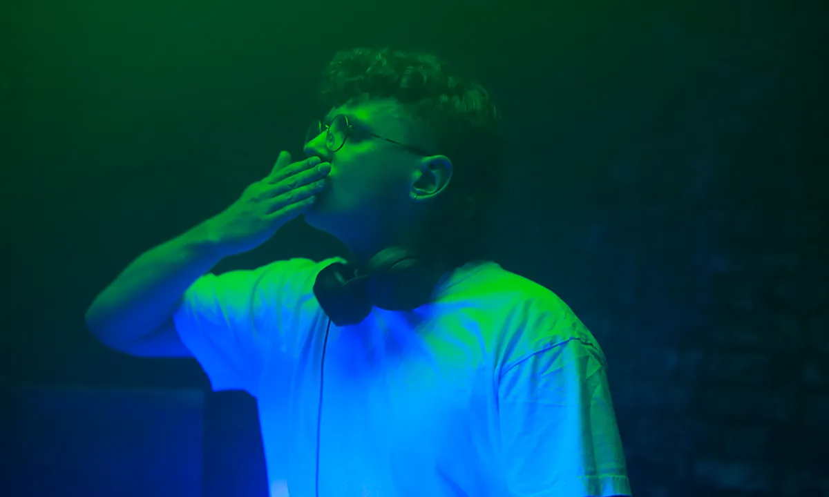 A male DJ blows a kiss to the audience