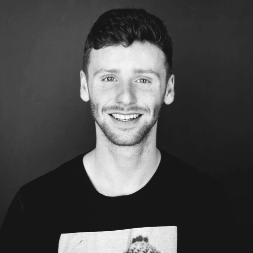 Online music production tutor Zack smiling in a professional press photo for London Sound Academy.