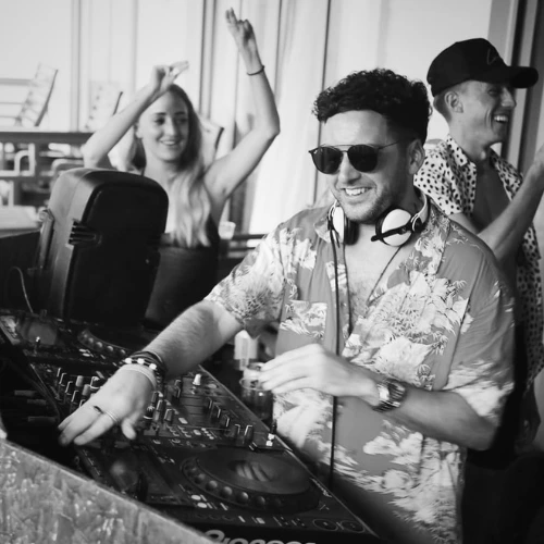 London Sound Academy DJ instructor Dave DJing with a big grin on his face during an international DJ performance