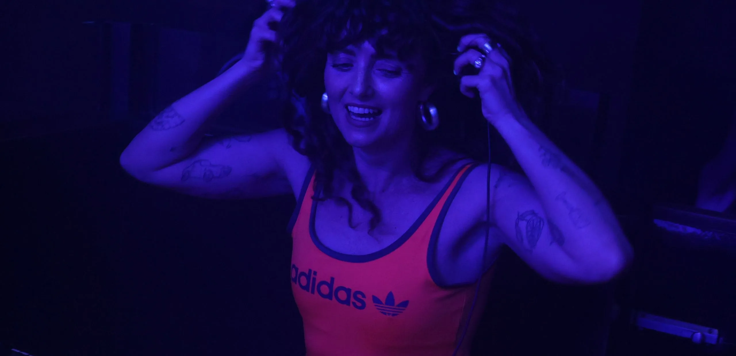 A woman DJs at a sporting event
