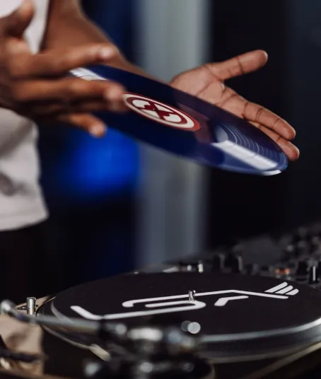 A man flips a record on a Technics turntable
