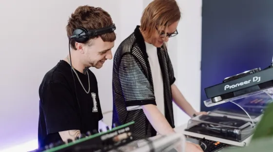 An Elite-level DJ course lesson with a senior instructor showing a student how to mix with multiple decks