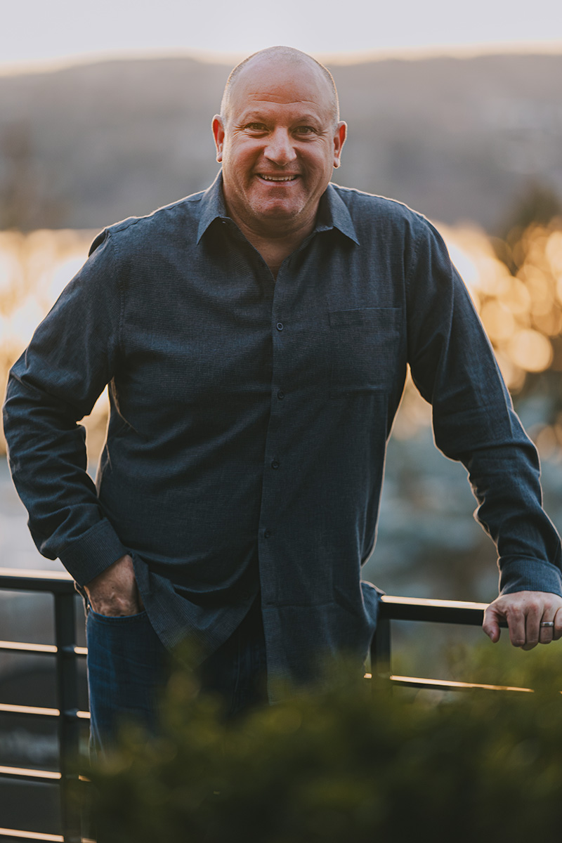 Headshot of Marc Rousso, founder of The Vision Academy, taken outside and softly lit by the evening sky.