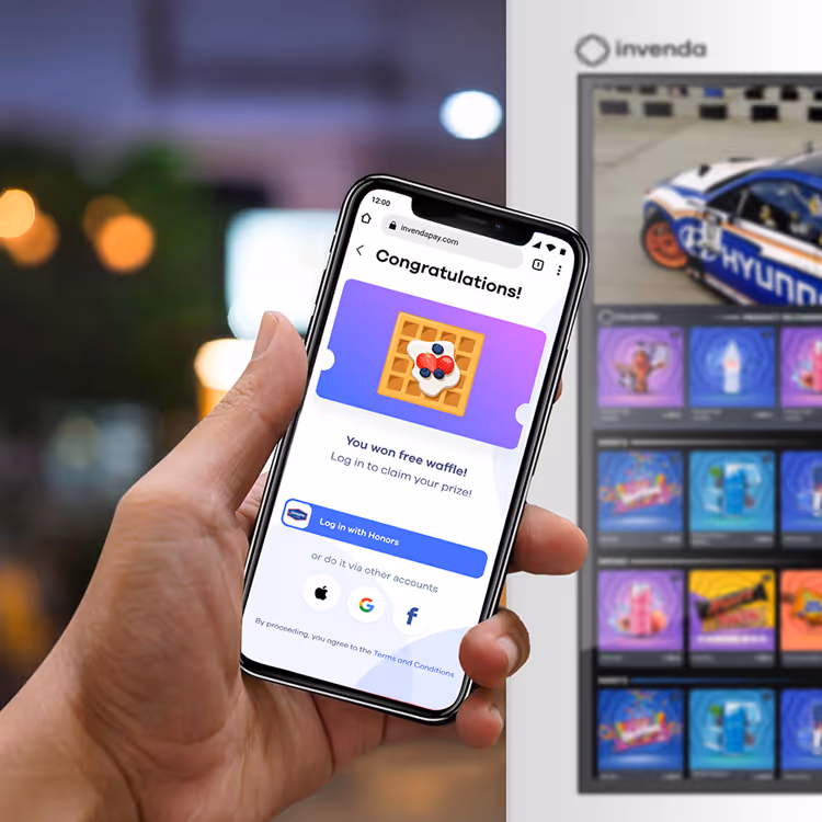 Hand holding a smartphone displaying a congratulations message for winning a free waffle with login options on InvendaPay website.